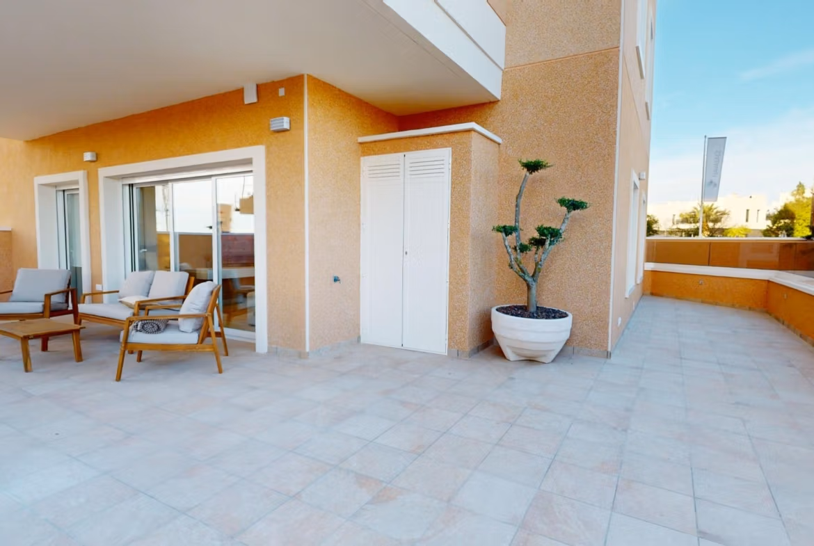Spacious sunlit terrace with modern outdoor seating at a 3-bedroom ground floor apartment in El Raso, Guardamar del Segura.