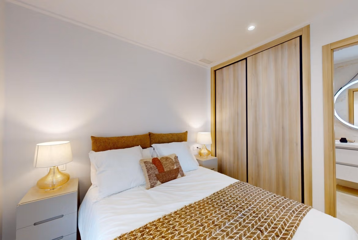 Bright and cozy bedroom with modern wooden wardrobe in luxury 3 bedroom ground floor apartment, El Raso, Guardamar del Segura.