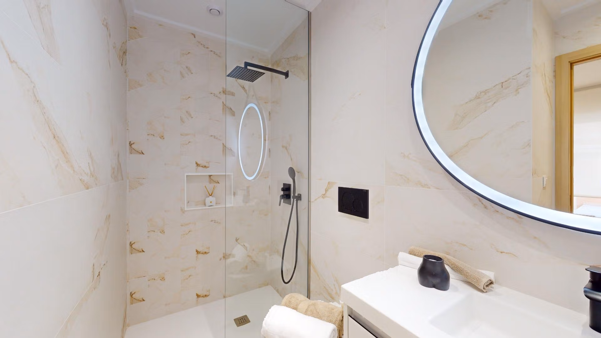 Bright modern bathroom with rain shower and illuminated round mirror in new build 3-bedroom apartment, El Raso, Guardamar del Segura