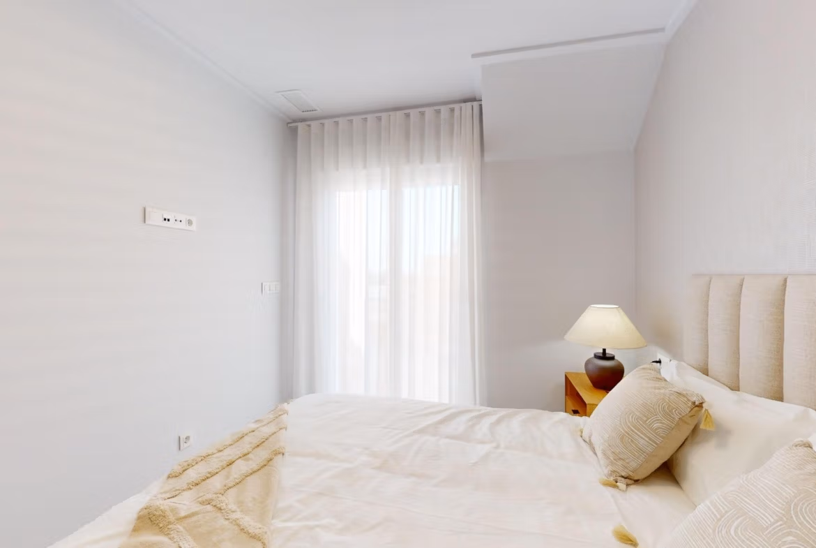 Bright, serene bedroom with soft natural light in a modern 3-bedroom penthouse with solarium in El Raso, Guardamar del Segura.