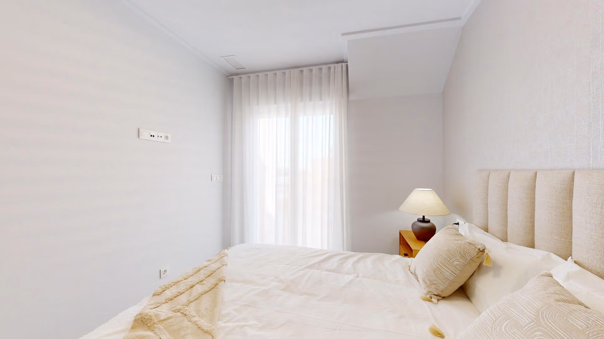 Bright, serene bedroom with soft natural light in a modern 3-bedroom penthouse with solarium in El Raso, Guardamar del Segura.