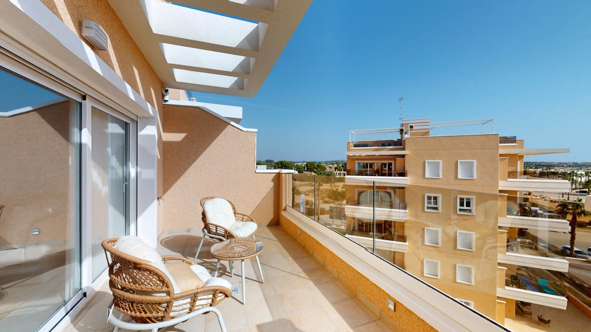 Bright sun-drenched terrace with cozy seating in a luminous 3-bedroom penthouse with solarium in El Raso, Guardamar del Segura.
