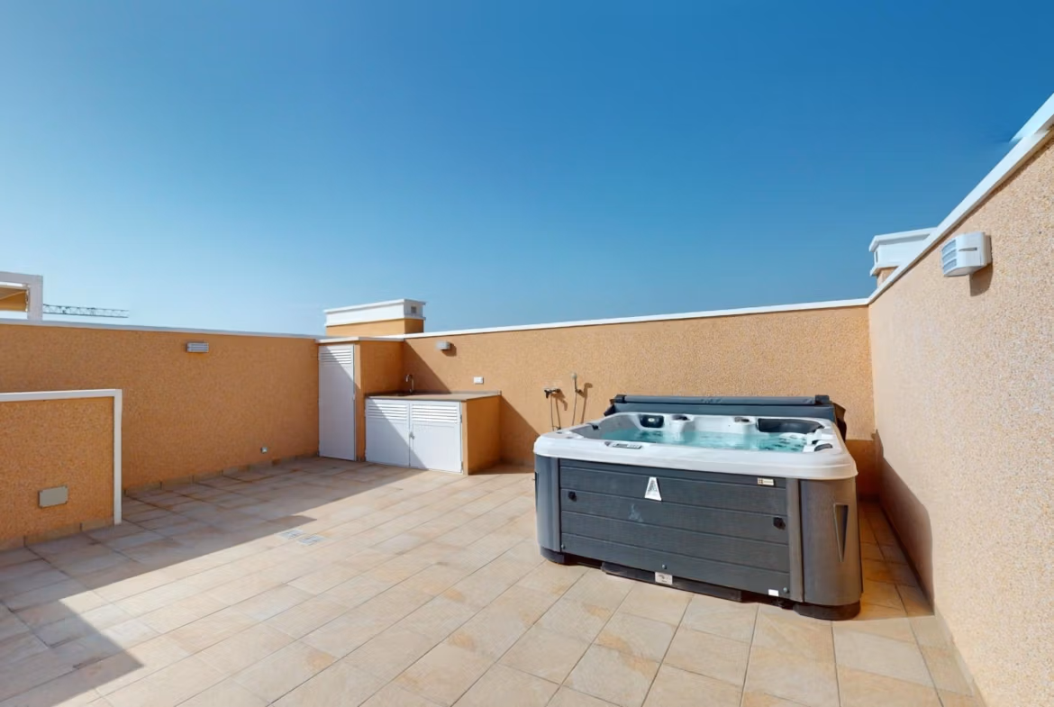Spacious sunlit solarium with modern hot tub in luminous 3-bedroom penthouse for sale in El Raso, Guardamar del Segura.