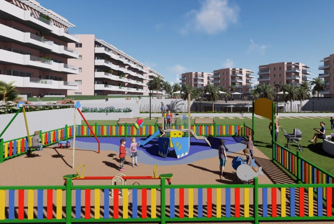 Colorful children's playground with swings and roundabout in a landscaped garden of new build 3-bedroom ground floor apartment in El Raso, Guardamar del Segura.