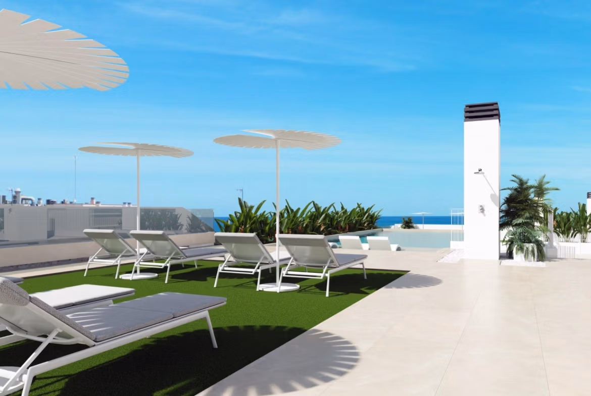 NEW-BUILD-RESIDENTIAL-IN-GUARDAMAR-DEL-SEGURA-13 Sun-drenched rooftop terrace with modern loungers and panoramic sea views at a new 2-bedroom apartment in Guardamar del Segura.