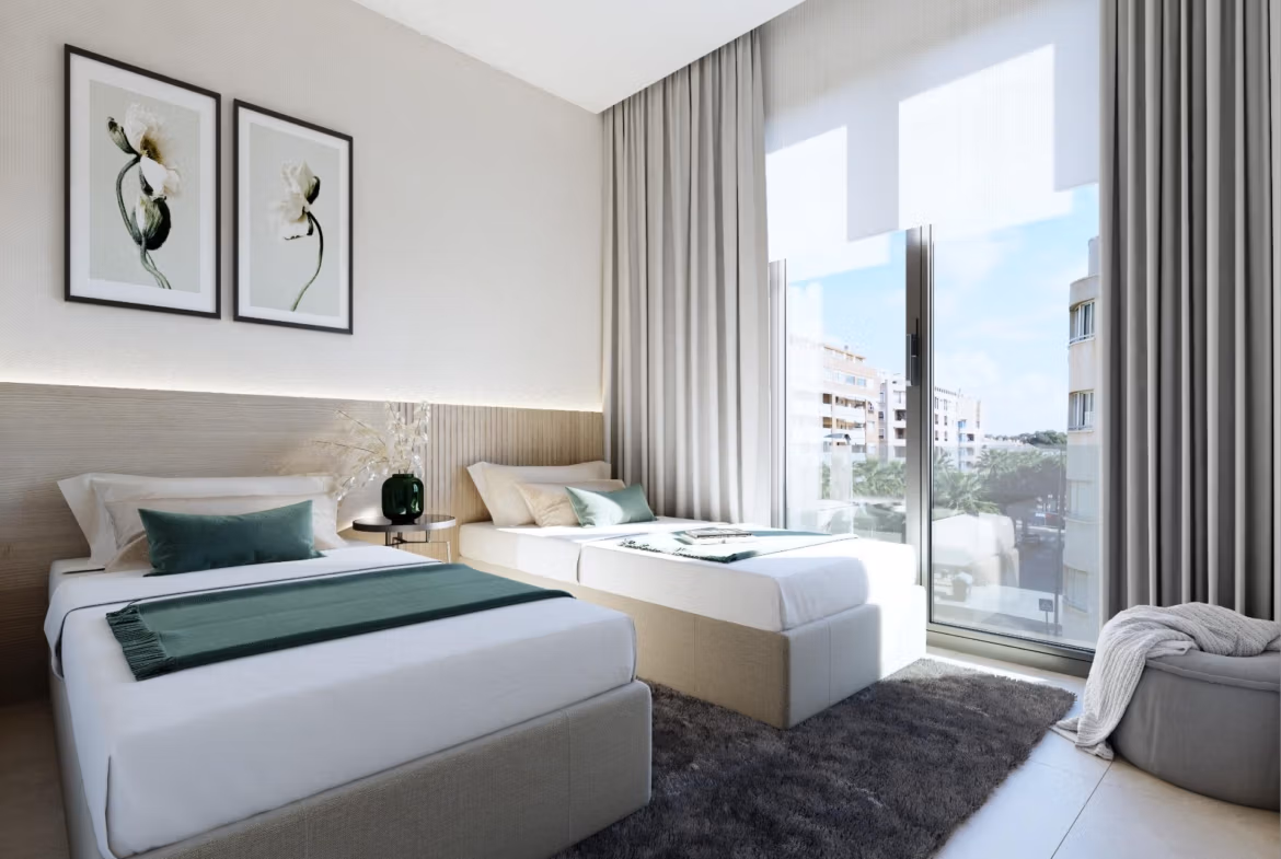 NEW-BUILD-RESIDENTIAL-IN-GUARDAMAR-DEL-SEGURA-9 Bright, modern 2-bedroom apartment bedroom with soft neutral tones and a sunlit balcony view in Guardamar del Segura near the beach.