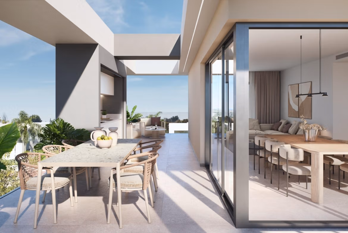 Sun-drenched modern terrace with elegant dining area and lush plants in 3-bedroom penthouse at Santa Rosalía Lake and Life Resort