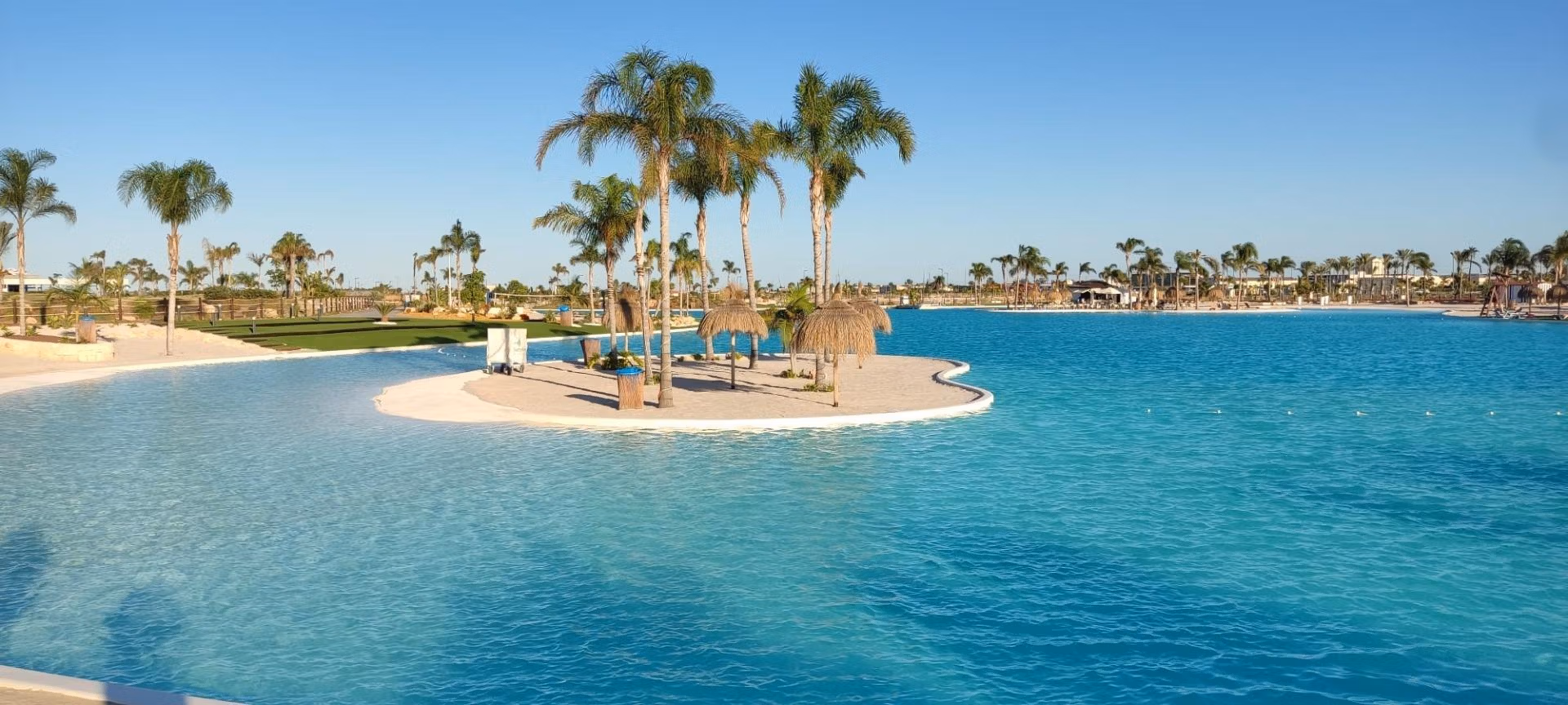 NEW-BUILD-RESIDENTIAL-IN-PRIVATE-GATED-RESORT-IN-PROVINCE-OF-MURCIA-18 Stunning sun-drenched lakefront view with palm-fringed lagoon at Santa Rosalía Lake and Life Resort penthouse for sale