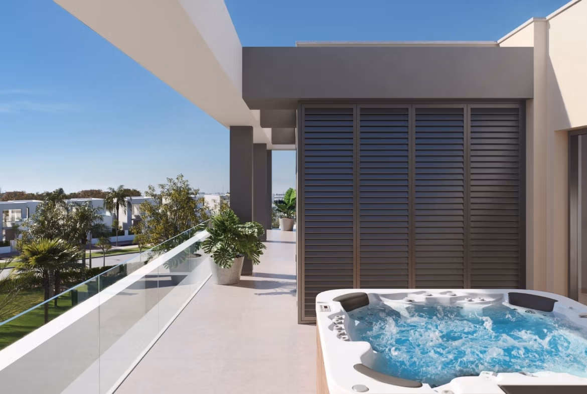 Sun-drenched penthouse solarium with bubbling jacuzzi, glass railing, and lush greenery at Santa Rosalía Lake and Life Resort