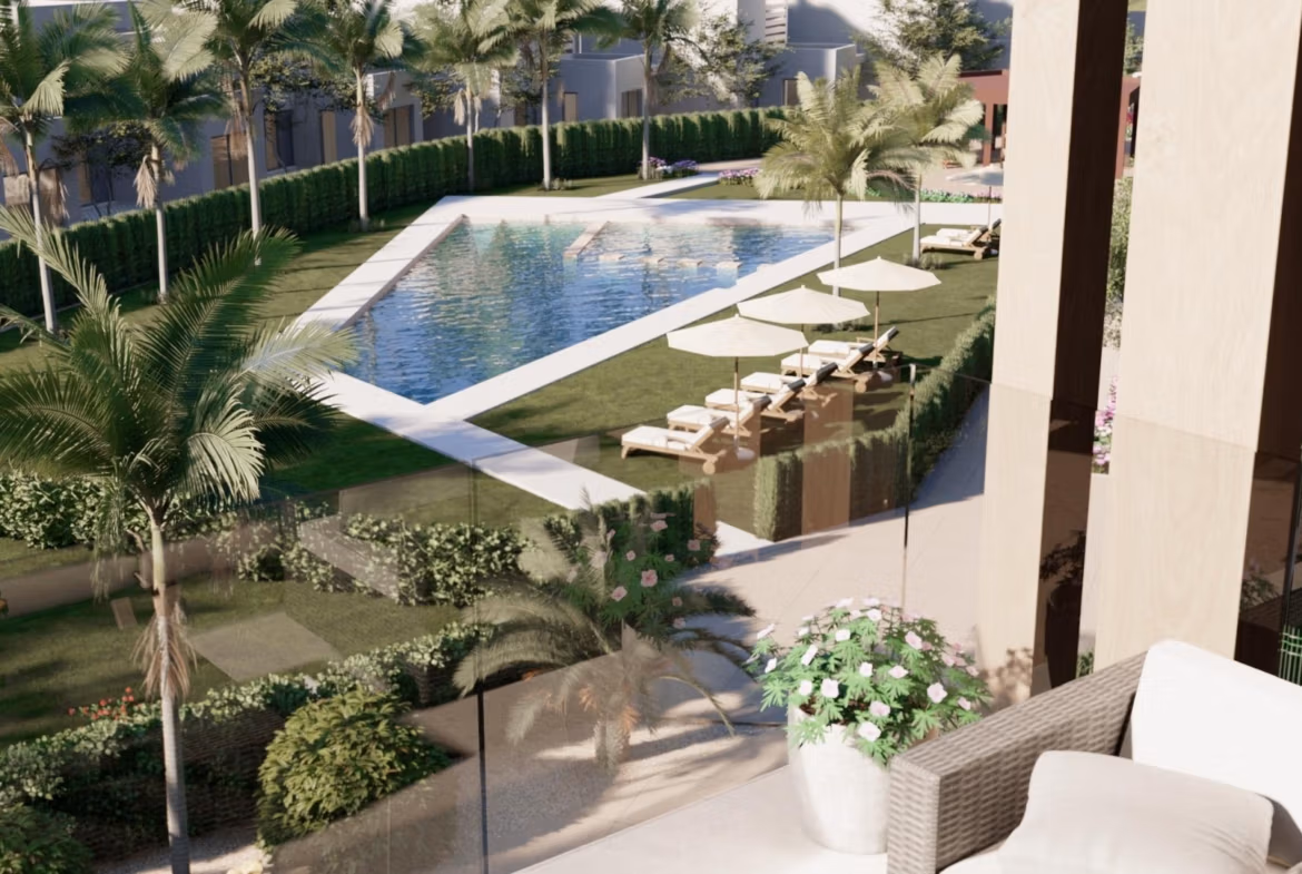 Sun-drenched terrace with modern outdoor seating overlooking a landscaped pool at the 3-bedroom penthouse in Santa Rosalía Lake and Life Resort.