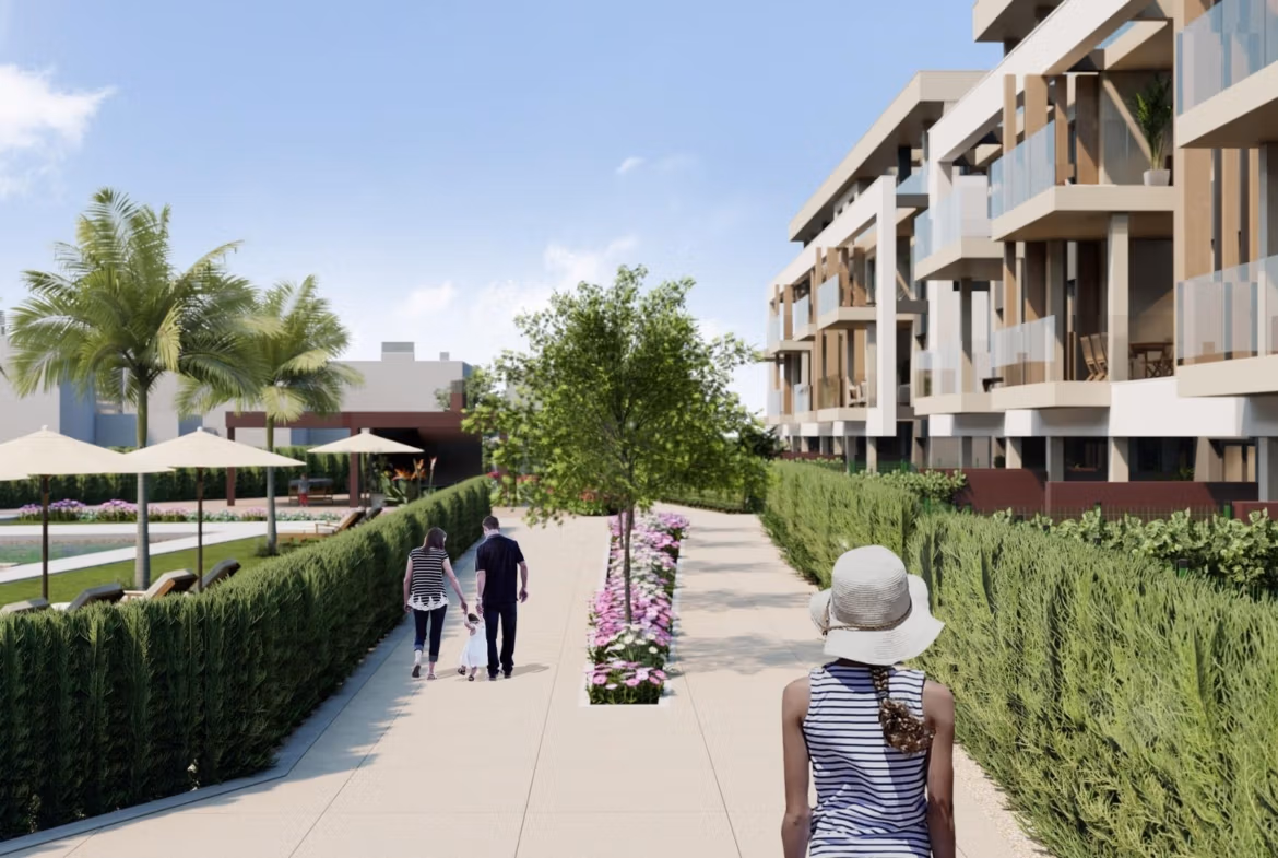 Lush landscaped walkway beside modern Santa Rosalía Lake and Life Resort penthouse with vibrant greenery and serene outdoor spaces.