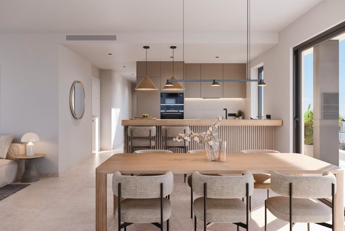 Bright, modern open-plan dining and kitchen area in the luxurious 3-bedroom penthouse at Santa Rosalía Lake and Life Resort.
