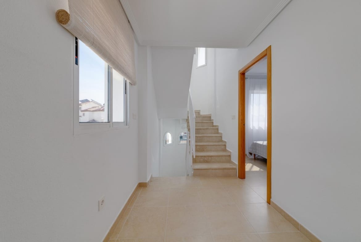Bright minimalist staircase and hallway with natural light in a key ready 3 bedroom villa in El Oasis, San Fulgencio.