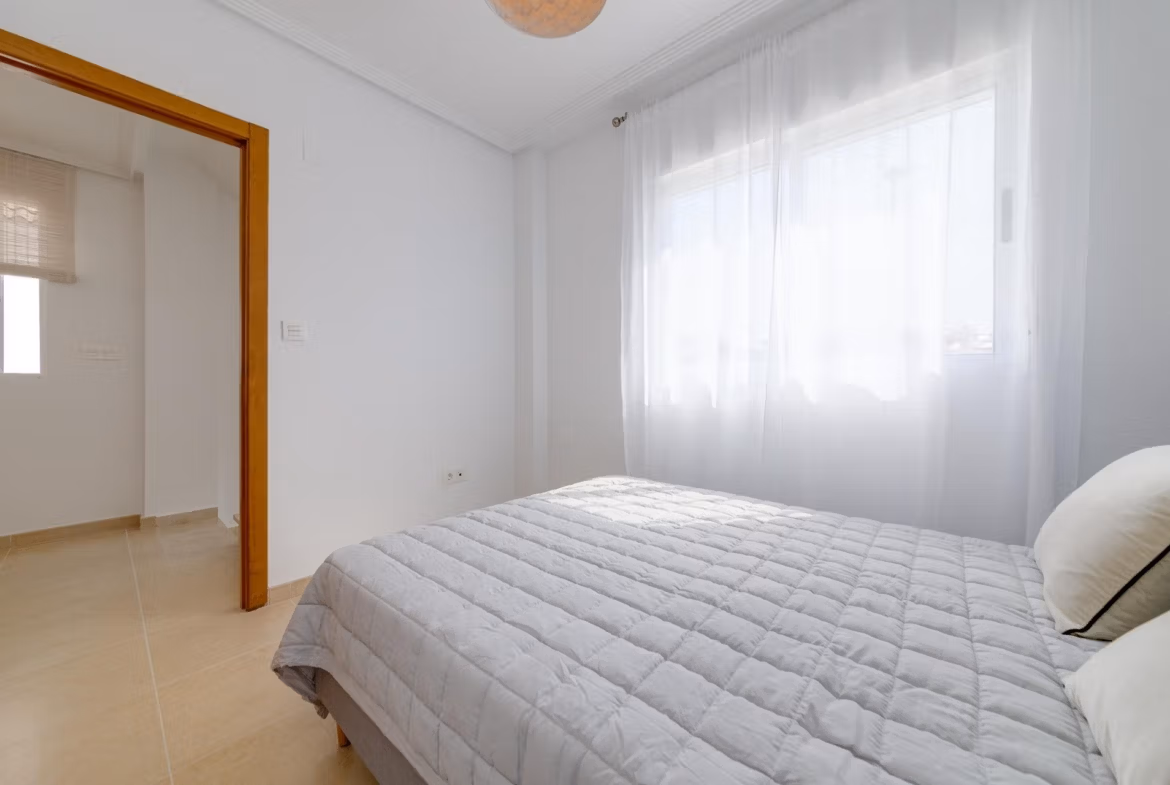 Bright and cozy bedroom with soft natural light in a key ready 3 bedroom villa in El Oasis, San Fulgencio.
