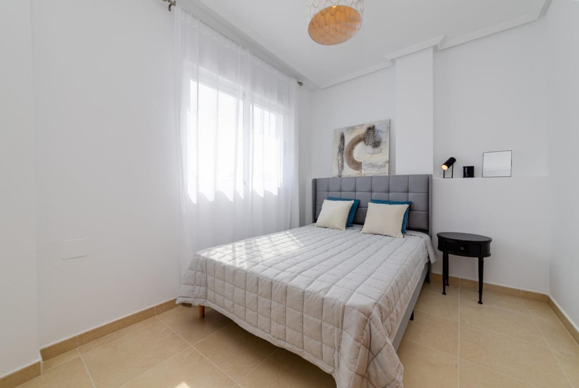 Bright and airy bedroom with modern decor in a key ready 3 bedroom villa in El Oasis, San Fulgencio