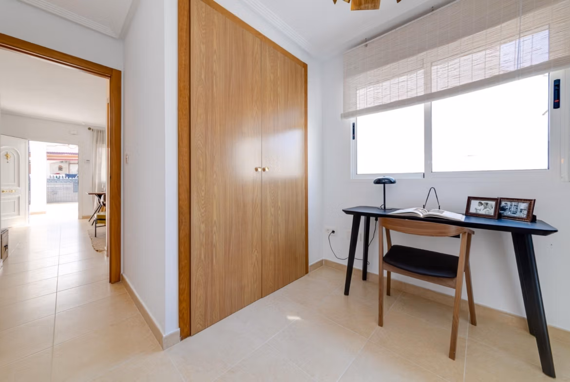 NEW-BUILD-RESIDENTIAL-IN-SAN-FULGENCIO-22 Bright, elegant study area with built-in wooden closet in a 2-bedroom semi-detached villa at El Oasis La Marina Urbanisation.
