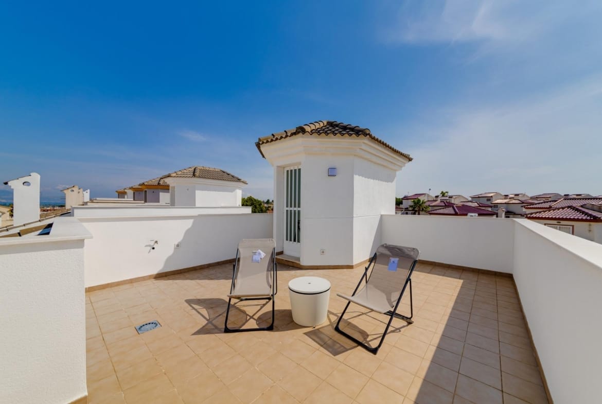 Spacious sun-drenched solarium with modern seating on a 3-bedroom villa in exclusive El Oasis, San Fulgencio.