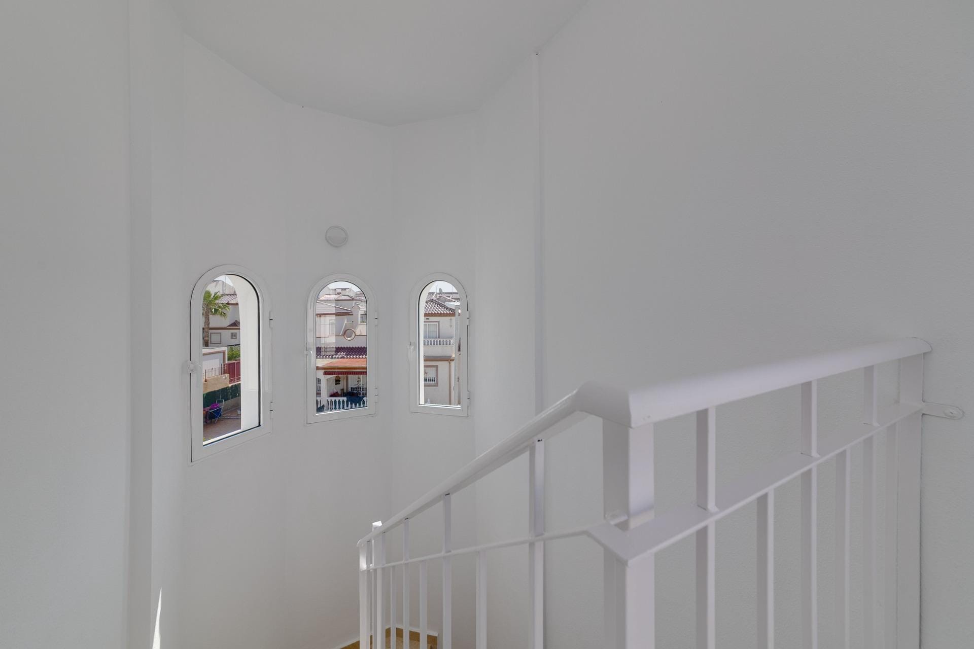NEW-BUILD-RESIDENTIAL-IN-SAN-FULGENCIO-28 Bright airy staircase with elegant arched windows in a modern 3-bedroom villa at El Oasis, San Fulgencio.