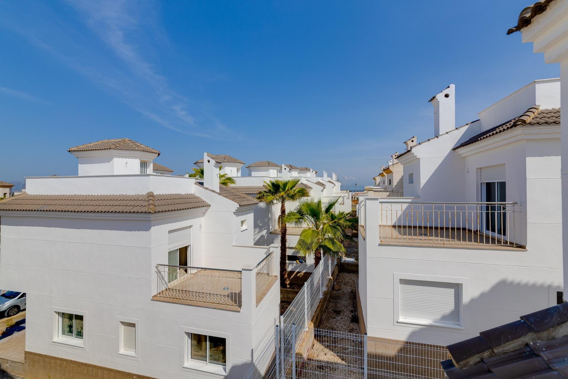 NEW-BUILD-RESIDENTIAL-IN-SAN-FULGENCIO-33 Bright sunlit exterior of modern 3 bedroom villas with private balconies and landscaped pathways in El Oasis, San Fulgencio.