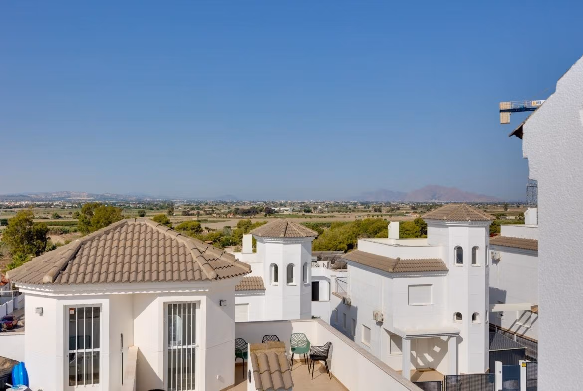 NEW-BUILD-RESIDENTIAL-IN-SAN-FULGENCIO-4 Panoramic sunlit terrace with scenic views of whitewashed semi-detached villas in El Oasis La Marina Urbanisation.