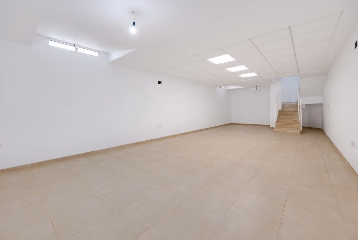 NEW-BUILD-RESIDENTIAL-IN-SAN-FULGENCIO-7 Spacious, bright open basement with tiled floors and modern lighting in 2 bedroom semi-detached villa in El Oasis La Marina Urbanisation
