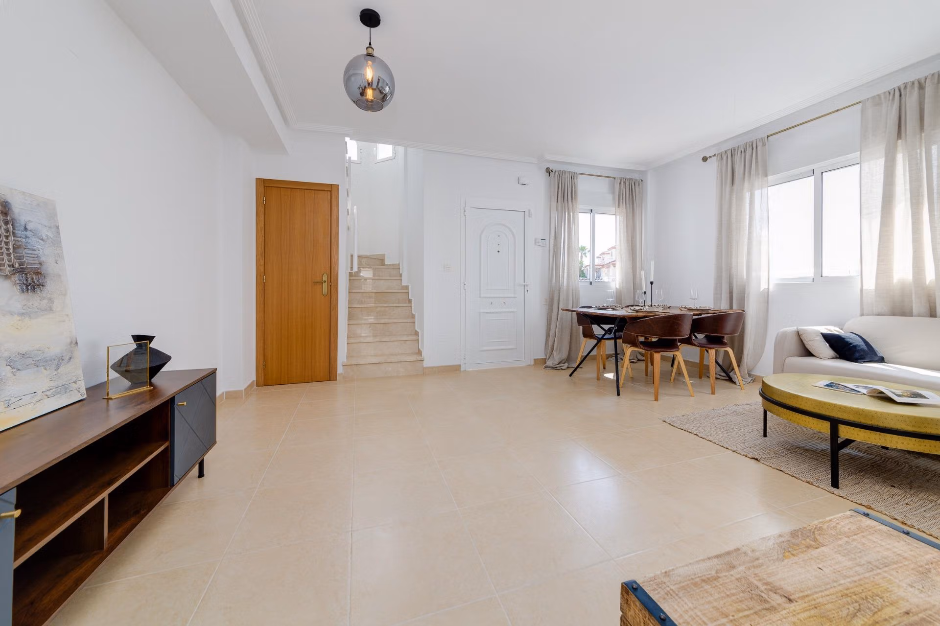 NEW-BUILD-RESIDENTIAL-IN-SAN-FULGENCIO-9 Bright, airy living and dining area with modern decor in a 2-bedroom semi-detached villa at El Oasis La Marina Urbanisation.
