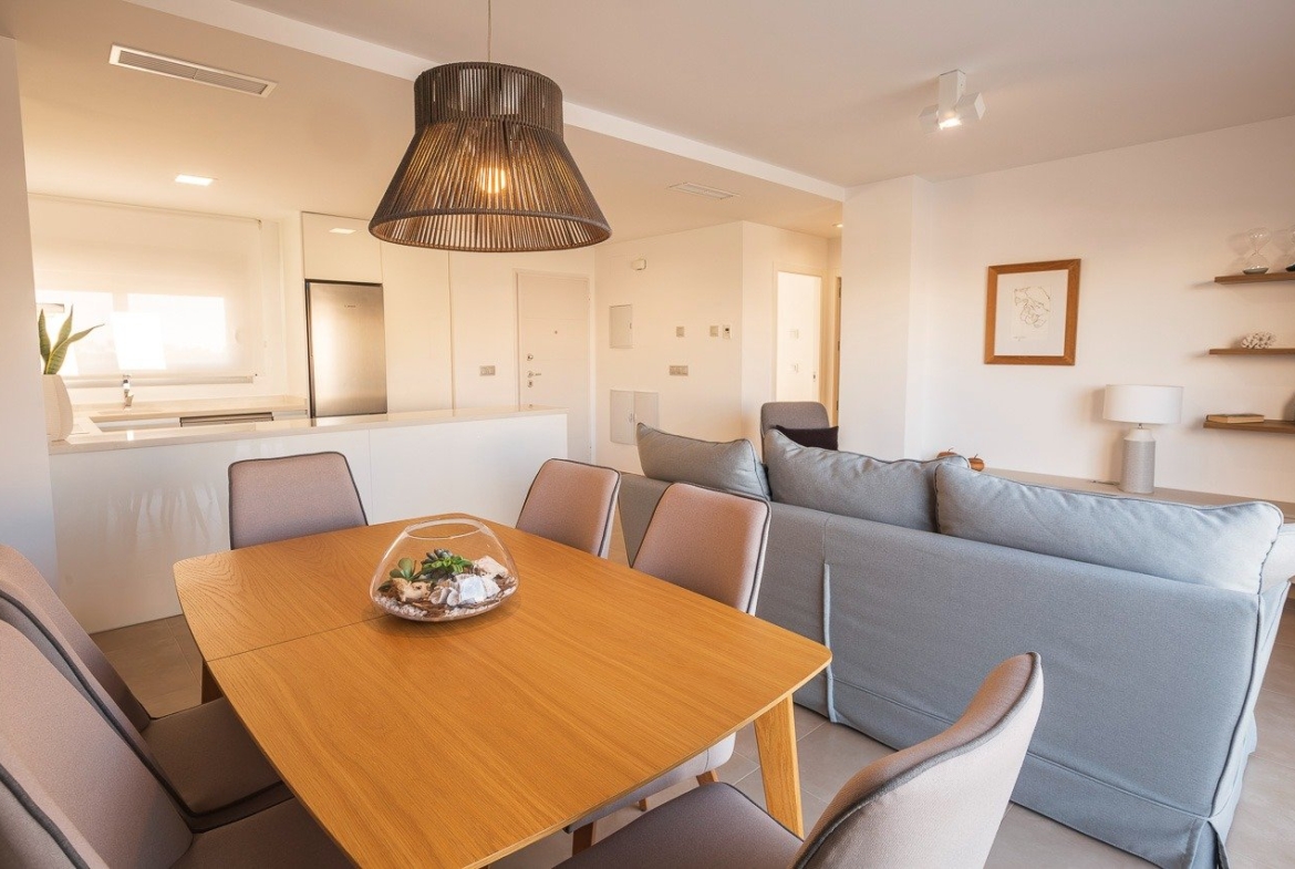 Bright open-plan living and dining area in a modern 2-bedroom top floor apartment at Vistabella Golf, Orihuela.