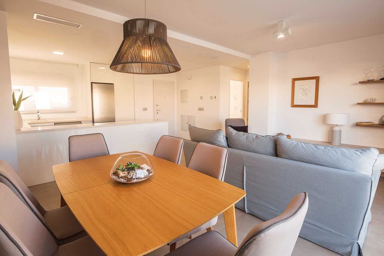 Bright open-plan living and dining area in a modern 2-bedroom top floor apartment at Vistabella Golf, Orihuela.