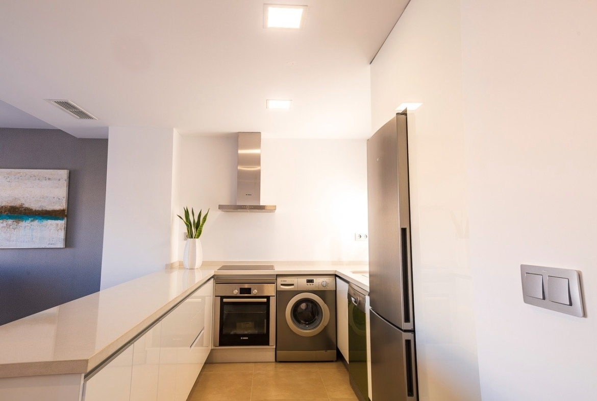 Modern, bright kitchen with sleek appliances in a key ready 2 bedroom top floor apartment at Vistabella Golf, Orihuela.
