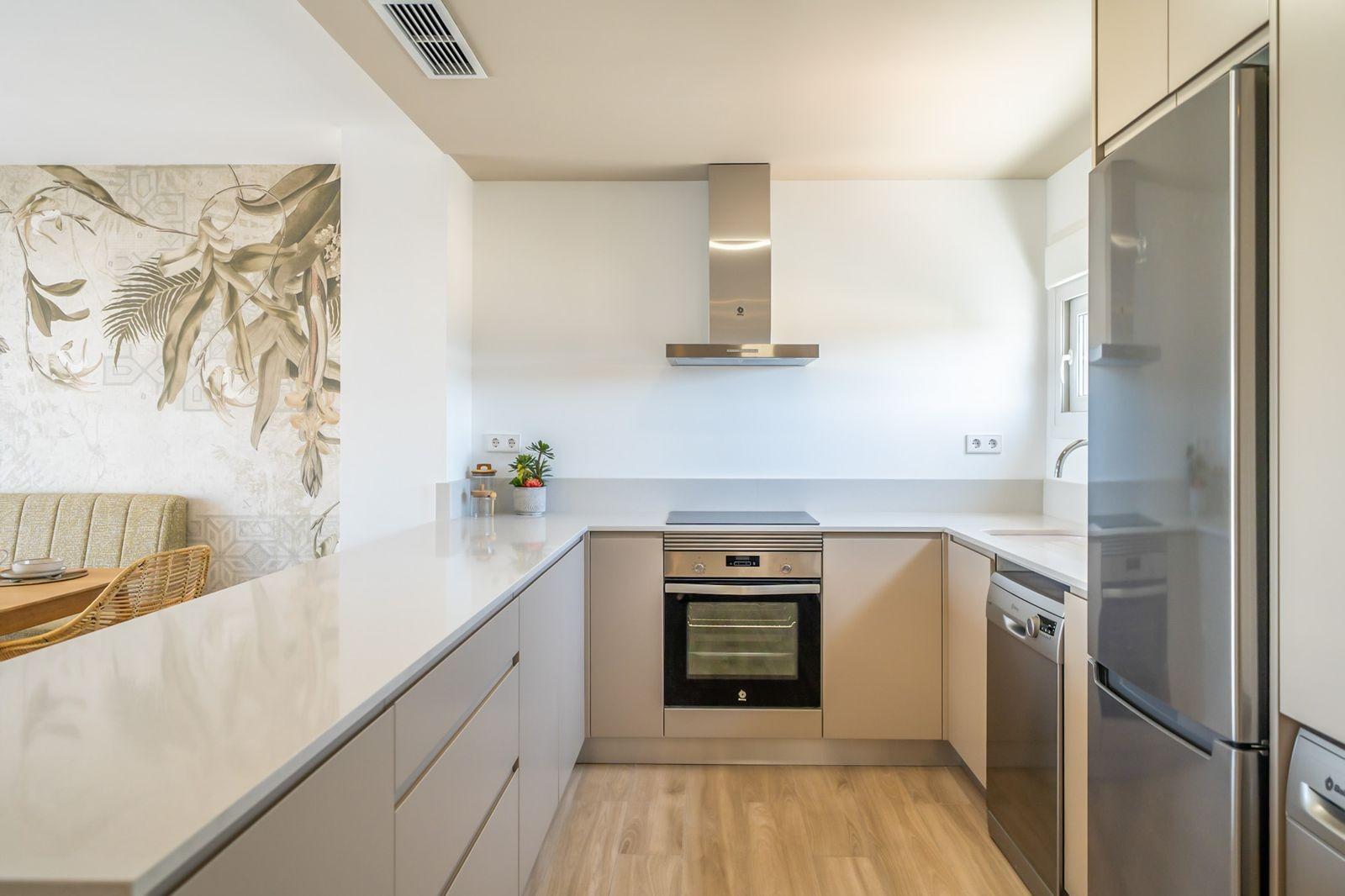 NEW-BUILD-RESIDENTIAL-OF-BUNGALOW-APARTMENTS-IN-VISTABELLA-12 Bright modern kitchen with sleek appliances and elegant countertops in a 2 bedroom top floor bungalow, Vistabella Golf Orihuela.