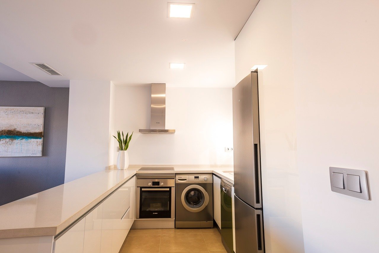 Modern, bright kitchen with sleek appliances in a key ready 2 bedroom top floor apartment at Vistabella Golf, Orihuela.