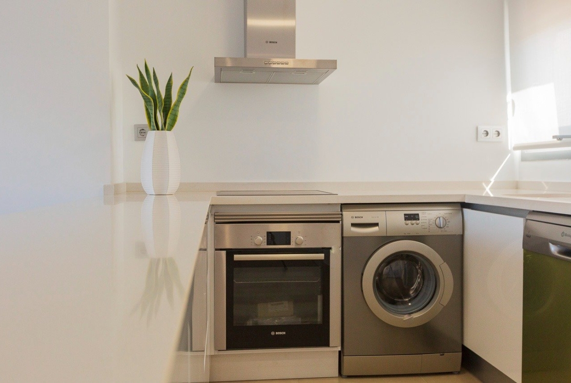 Modern bright kitchen with sleek appliances in luxury 2-bedroom top floor apartment in Vistabella Golf, Orihuela