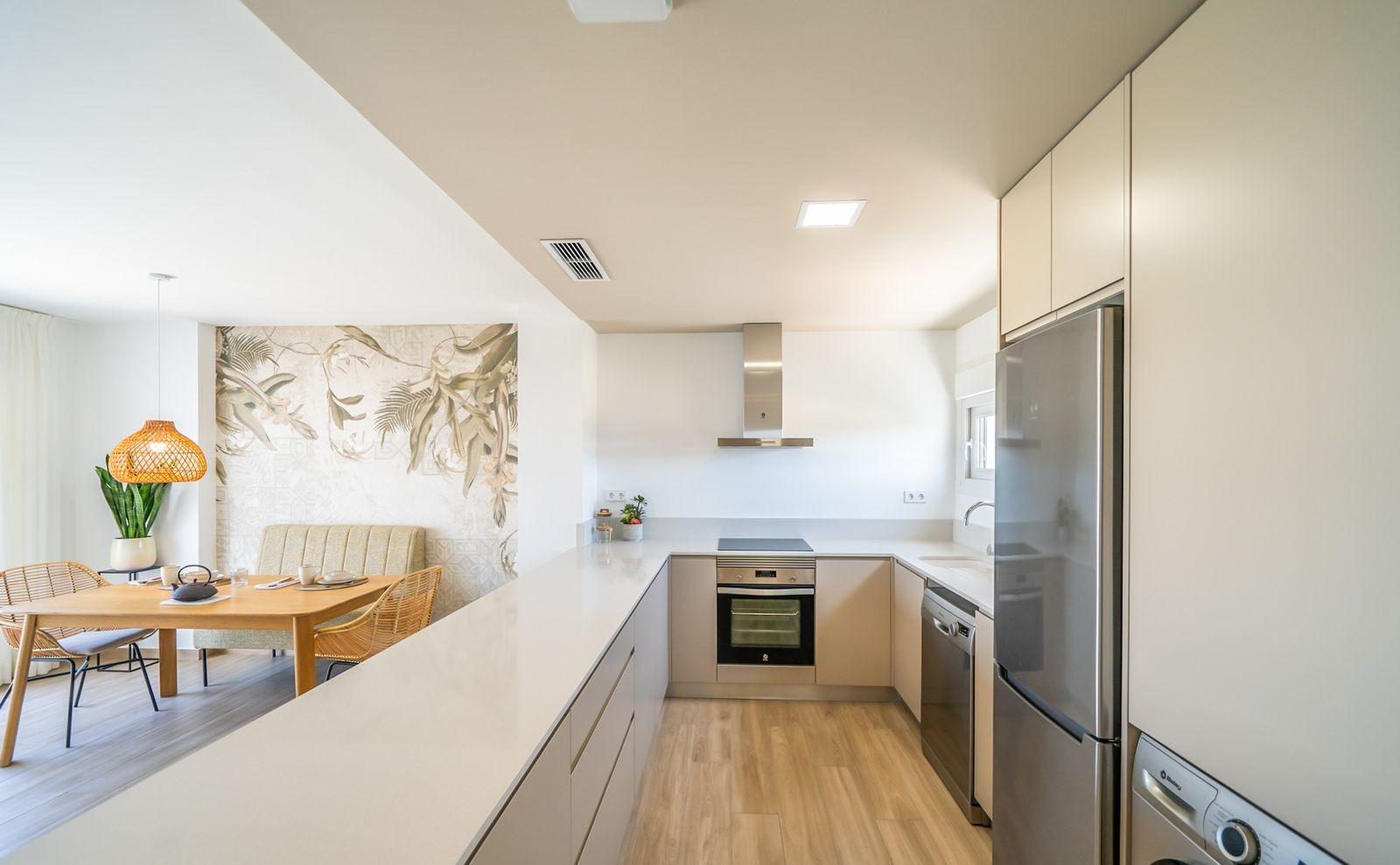 NEW-BUILD-RESIDENTIAL-OF-BUNGALOW-APARTMENTS-IN-VISTABELLA-13 Bright modern kitchen and dining area with sleek cabinetry in a top floor 2-bedroom bungalow at Vistabella Golf, Orihuela.