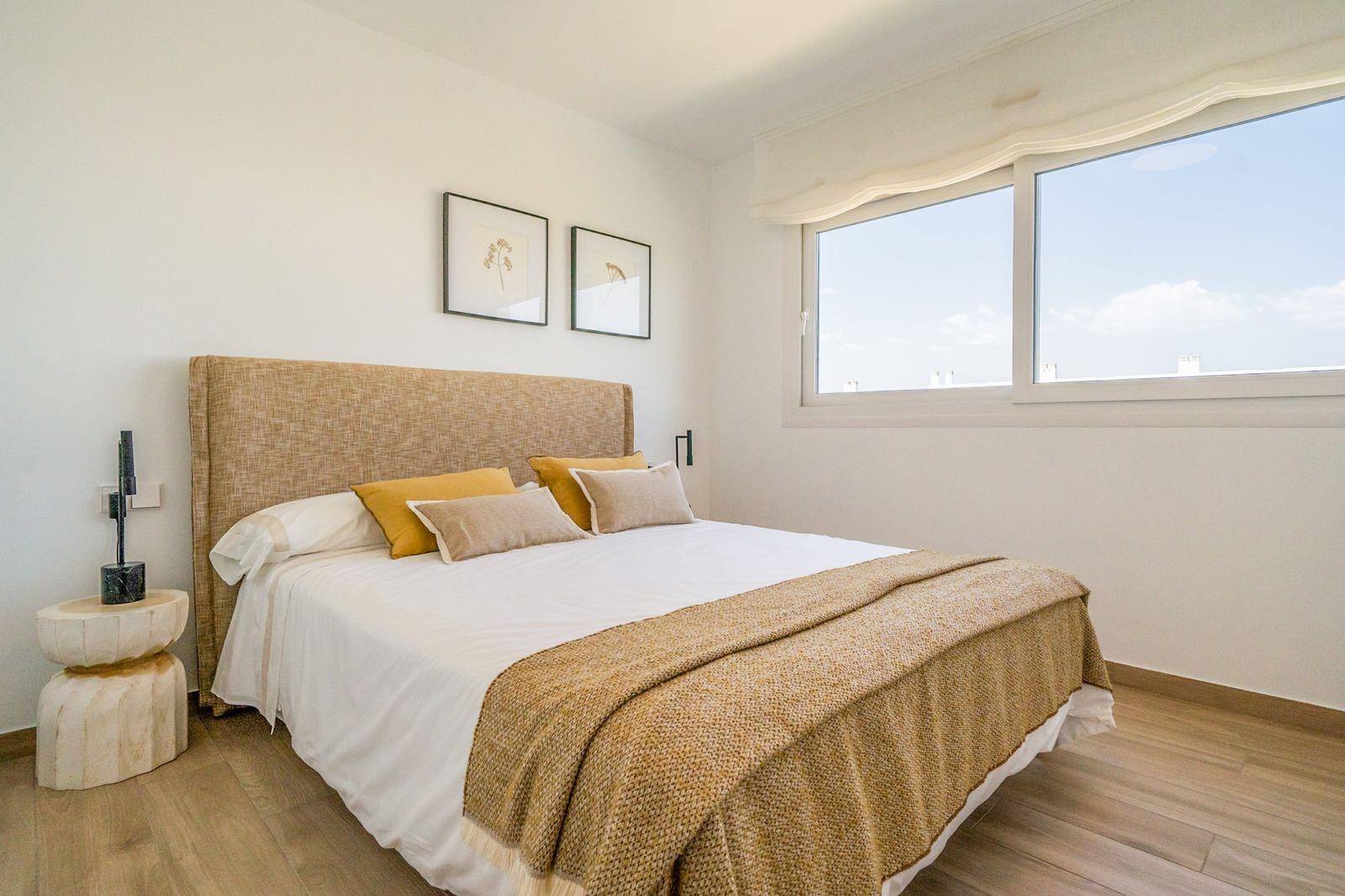 Bright, modern 2-bedroom townhouse bedroom in Vistabella Golf, Orihuela with natural light and warm, elegant décor.
