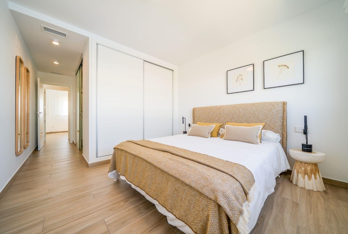 Bright modern bedroom with elegant decor and natural light in a 2-bedroom townhouse at Vistabella Golf, Orihuela.
