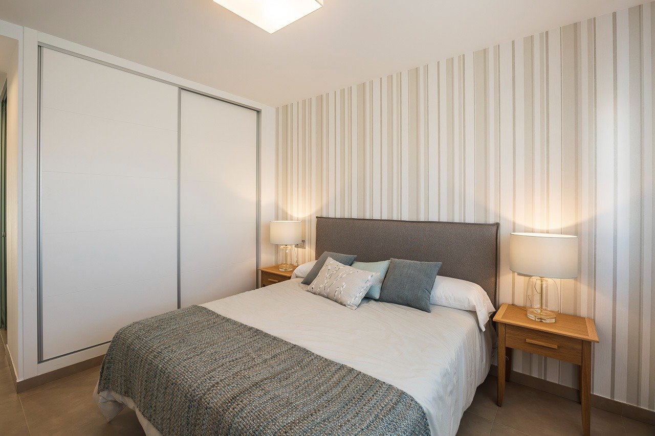 Bright and elegant bedroom with modern decor in a top floor 2-bedroom apartment at Vistabella Golf, Orihuela.