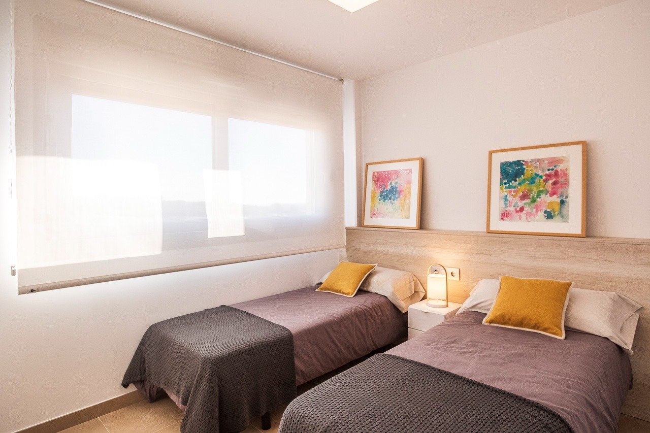 Bright and modern twin bedroom with soft natural light in a 2-bedroom top floor apartment in Vistabella Golf, Orihuela.