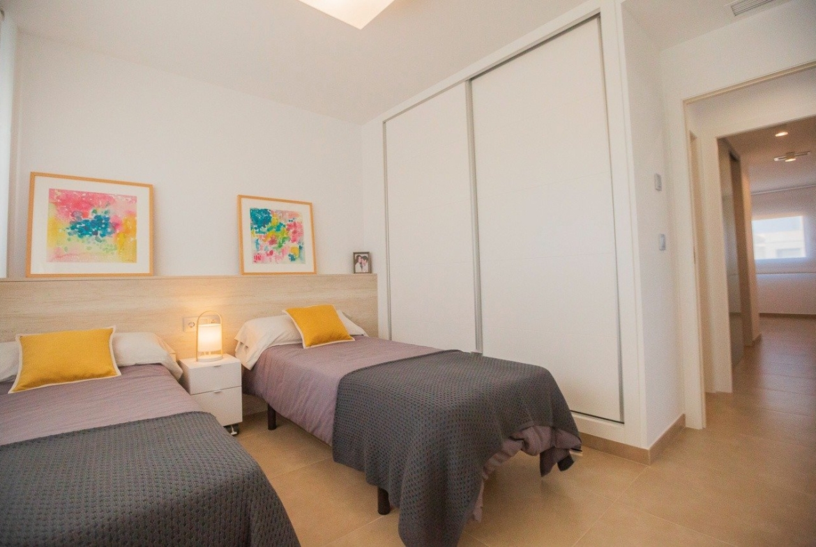 Bright and modern twin bedroom in a 2-bedroom top floor apartment with elegant decor in Vistabella Golf, Orihuela.