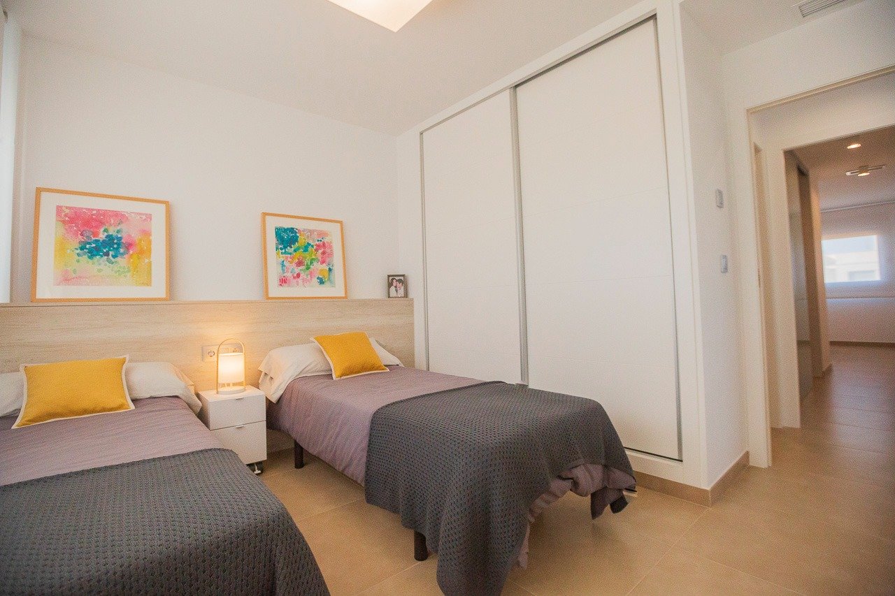 Bright and modern twin bedroom in a 2-bedroom top floor apartment with elegant decor in Vistabella Golf, Orihuela.