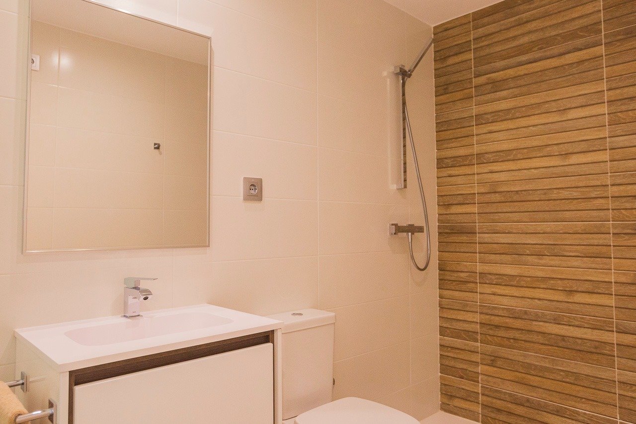 Modern, elegant bathroom with sleek fixtures and wood-effect tile shower in 2 bedroom top floor apartment, Vistabella Golf Orihuela