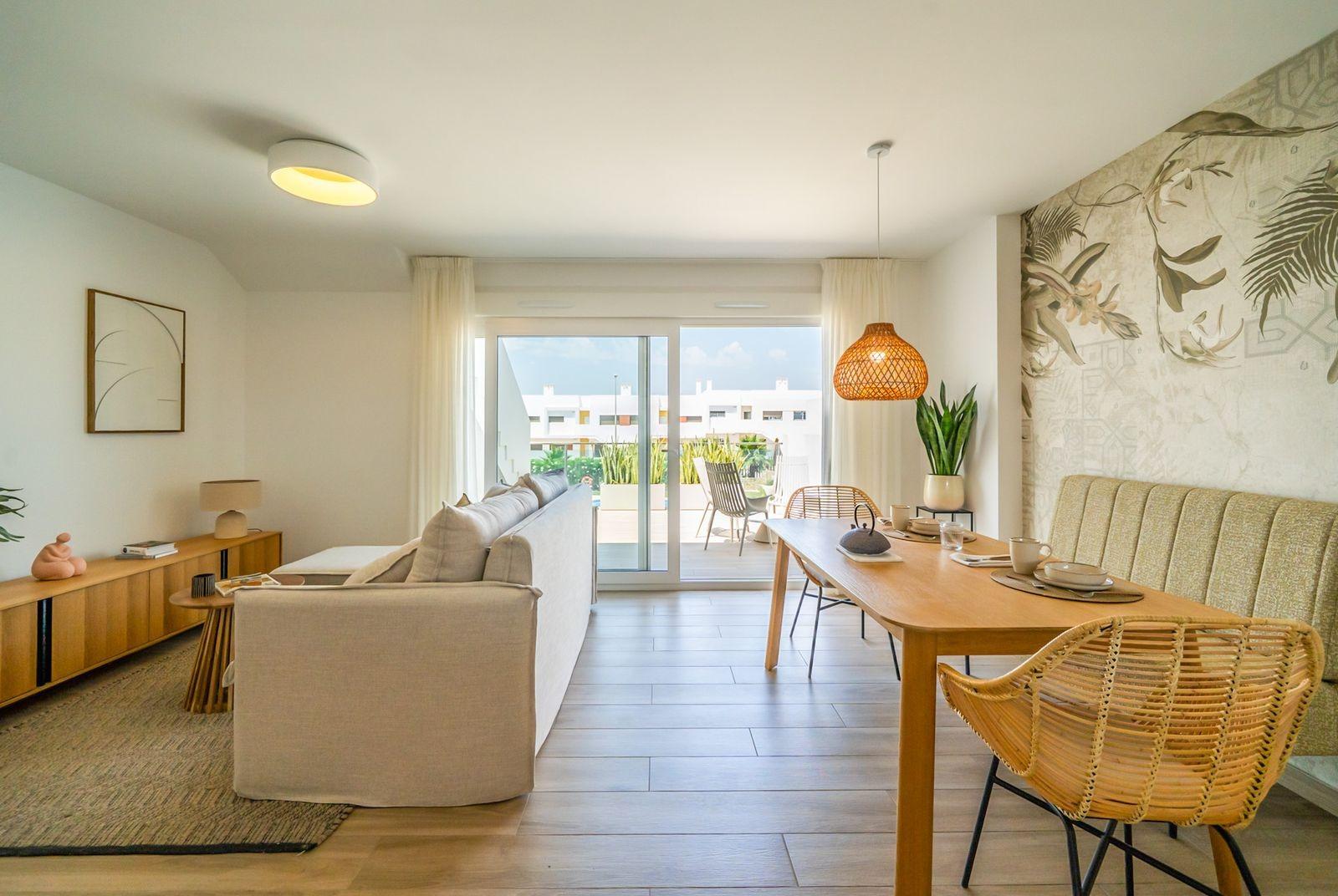 Bright open-plan living and dining area in modern 2-bedroom townhouse with garden in Vistabella Golf, Orihuela.