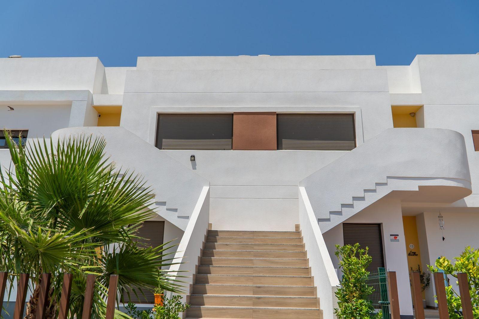 NEW-BUILD-RESIDENTIAL-OF-BUNGALOW-APARTMENTS-IN-VISTABELLA-2 Bright modern top floor bungalow with sleek staircase and lush landscaping in Vistabella Golf, Orihuela.