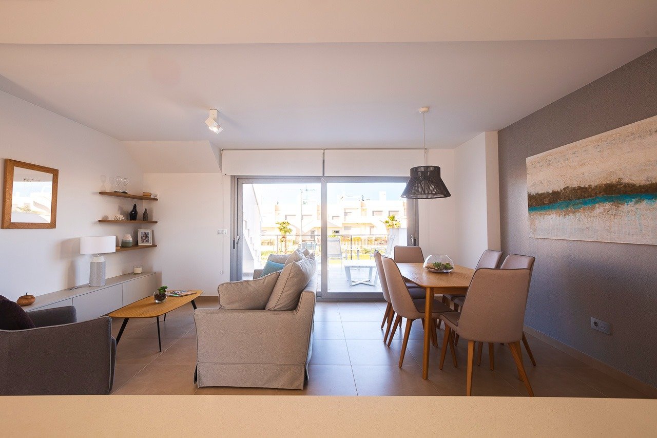 Bright and modern open-plan living and dining area in a top floor 2-bedroom apartment with terrace, Vistabella Golf Orihuela.