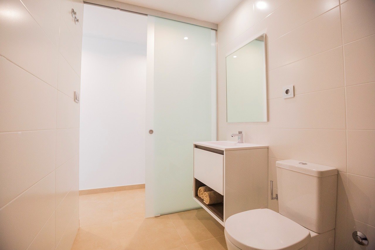 Minimalist modern bathroom with sleek fixtures in a top floor 2-bedroom apartment at Vistabella Golf, Orihuela.