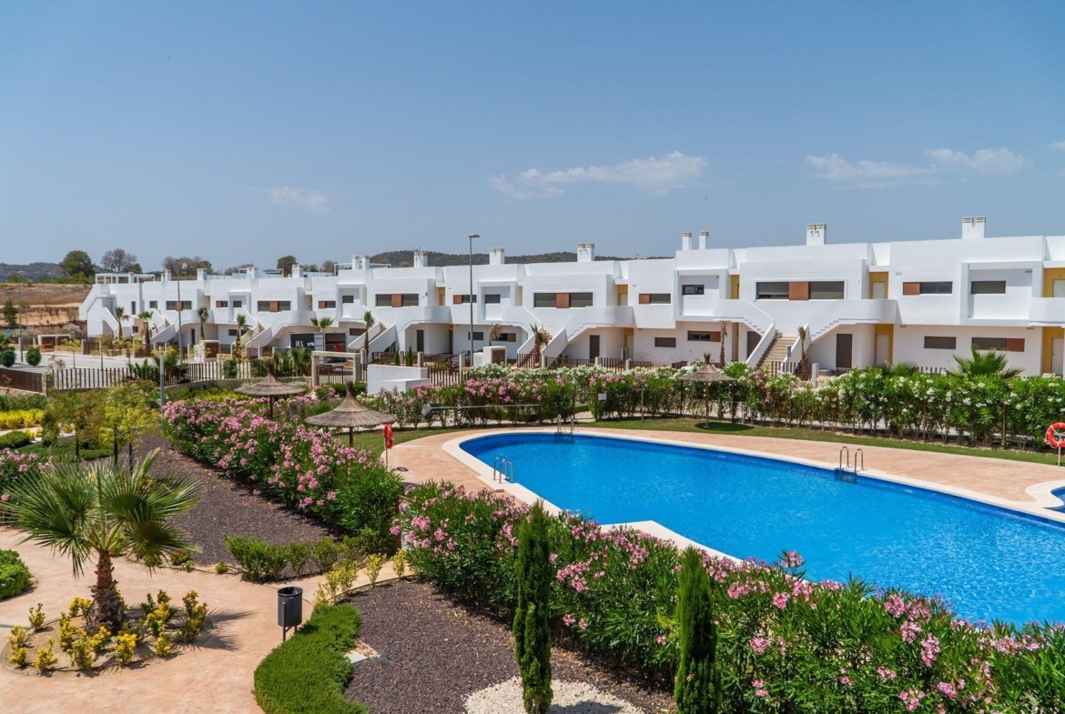 Spacious modern 2-bedroom townhouse in Vistabella Golf, Orihuela with vibrant landscaped gardens and sparkling communal pool.
