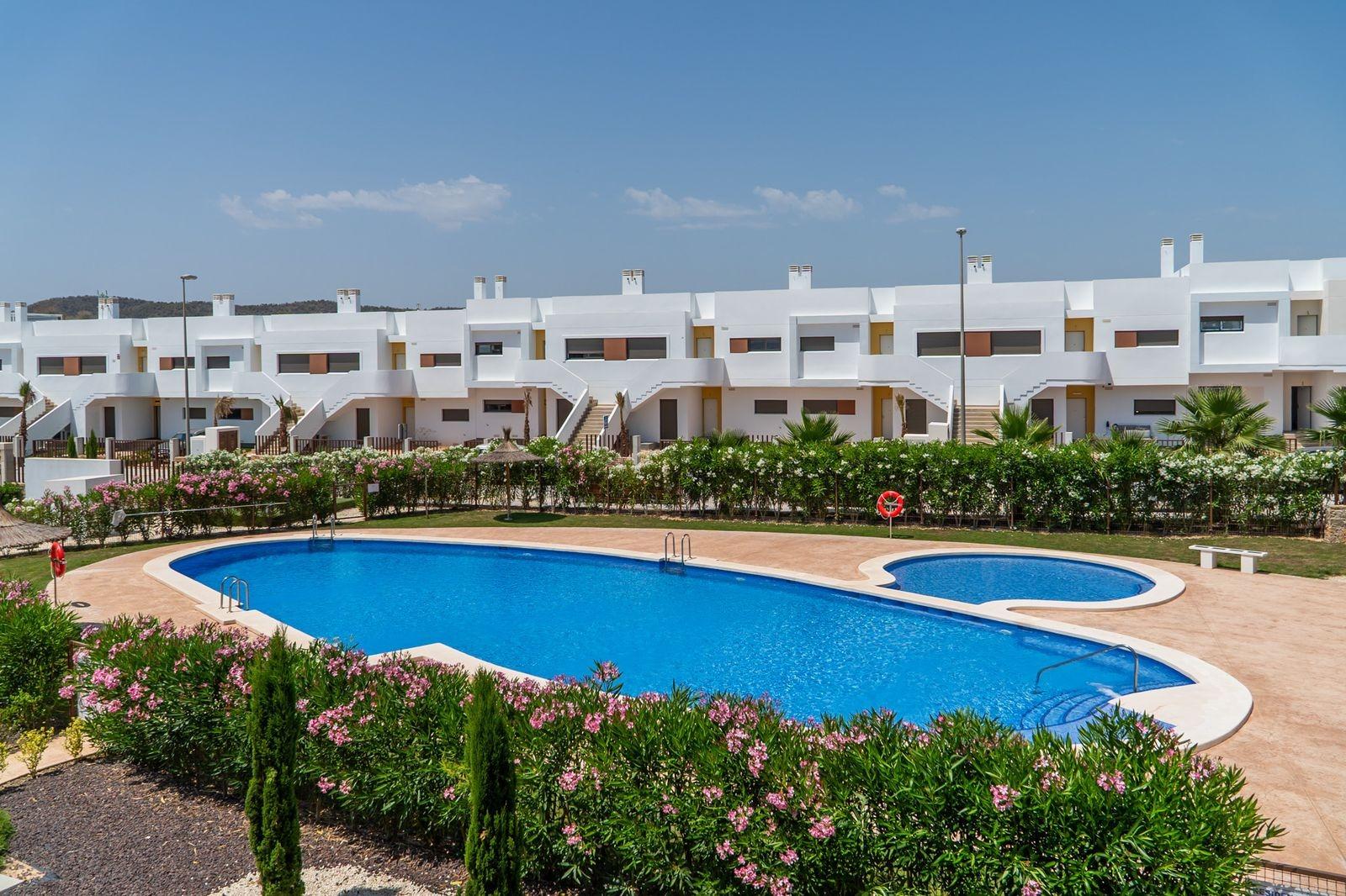 Sun-drenched modern 2-bedroom townhouse with landscaped garden and communal pool in Vistabella Golf, Orihuela.