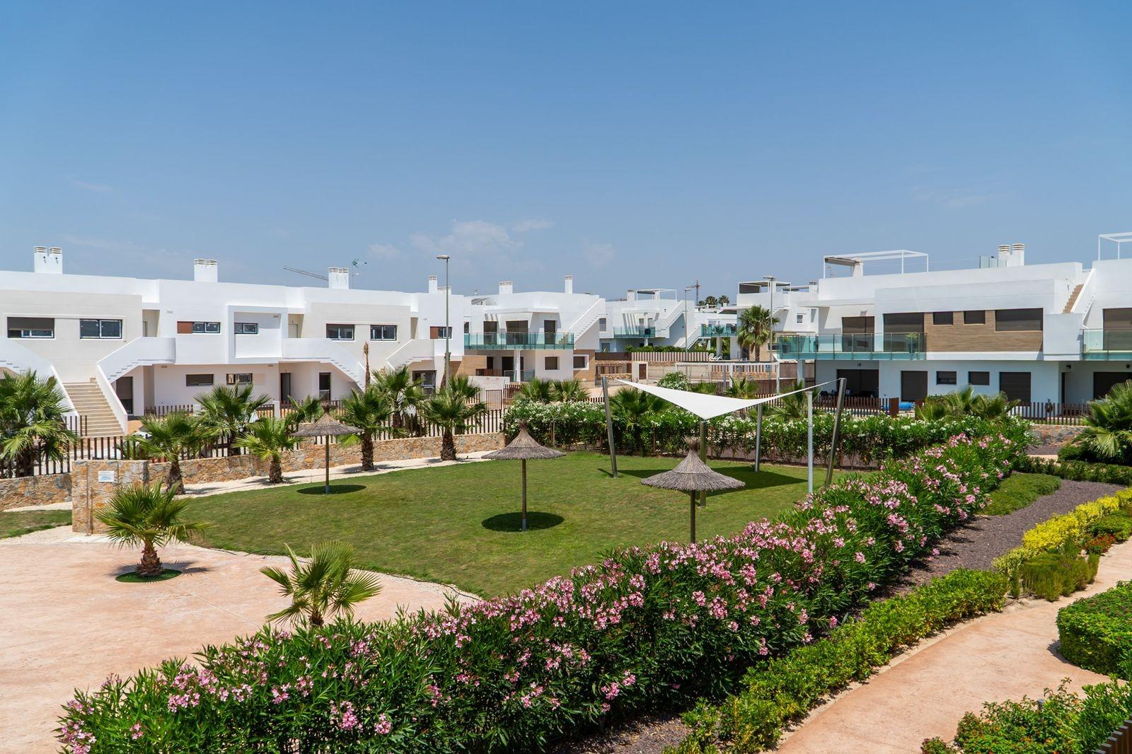 NEW-BUILD-RESIDENTIAL-OF-BUNGALOW-APARTMENTS-IN-VISTABELLA-23 Sun-drenched modern top floor 2-bedroom bungalow exterior with landscaped gardens and shaded solarium in Vistabella Golf, Orihuela