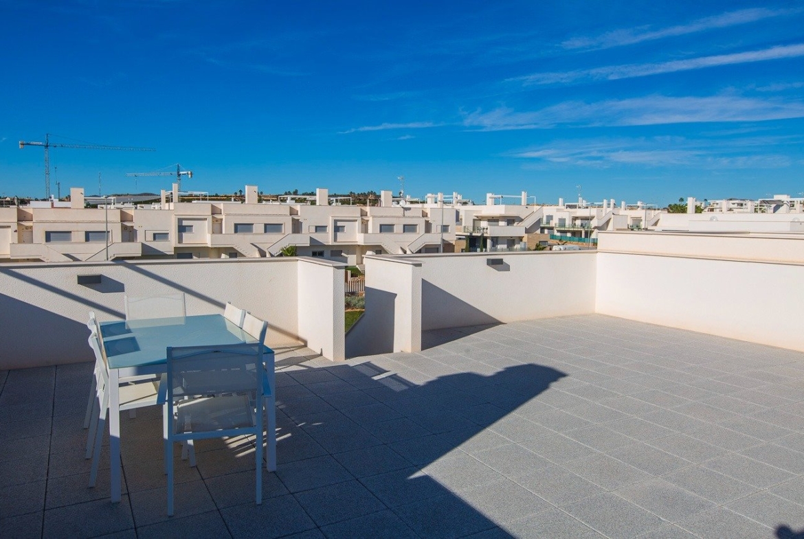 Spacious sun-drenched solarium with modern outdoor dining area in key ready 2-bedroom top floor apartment at Vistabella Golf, Orihuela