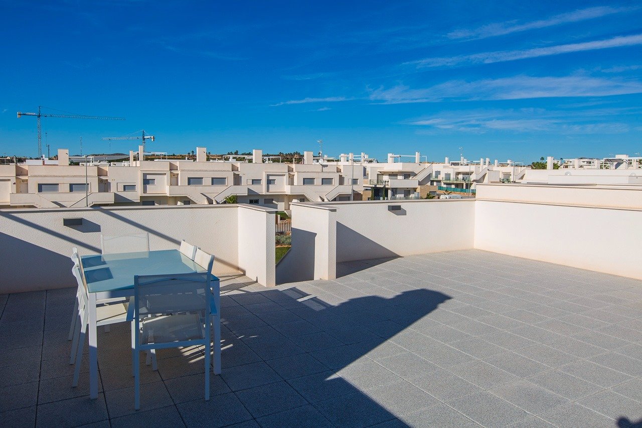 Spacious sun-drenched solarium with modern outdoor dining area in key ready 2-bedroom top floor apartment at Vistabella Golf, Orihuela