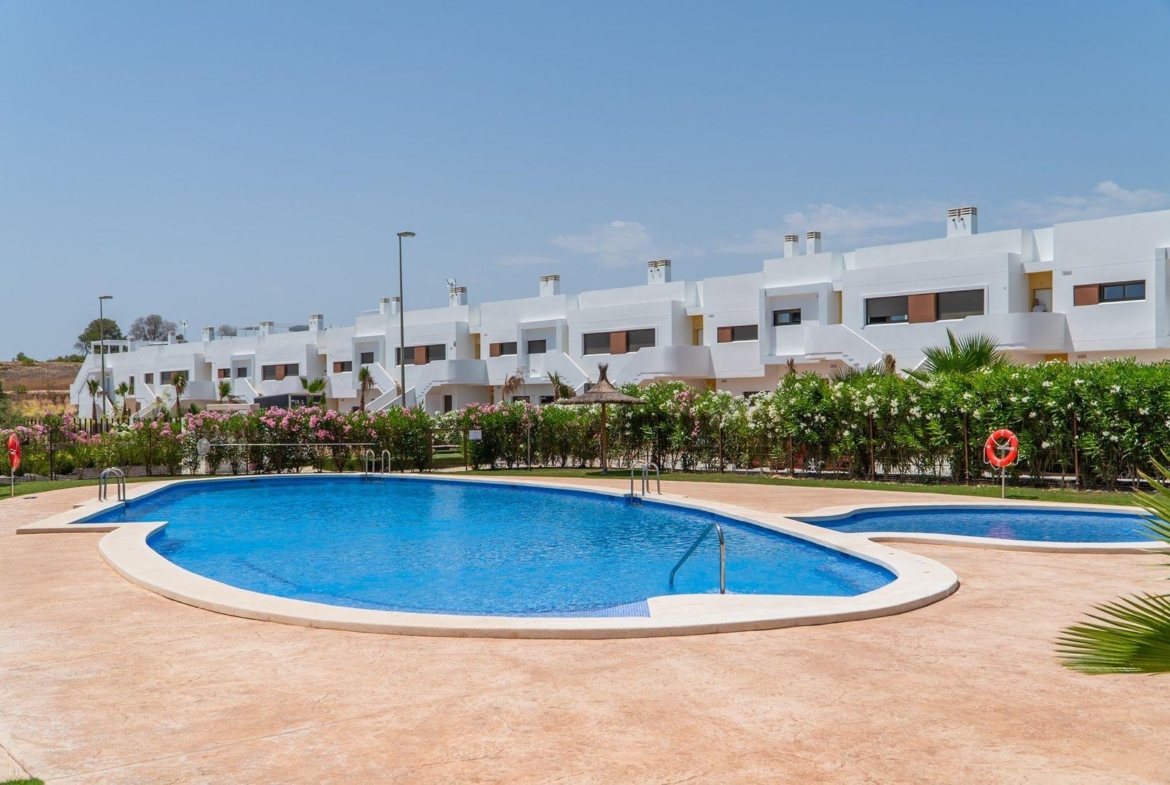 Modern top floor 2-bedroom bungalow with private landscaped pool area in sunlit Vistabella Golf, Orihuela.